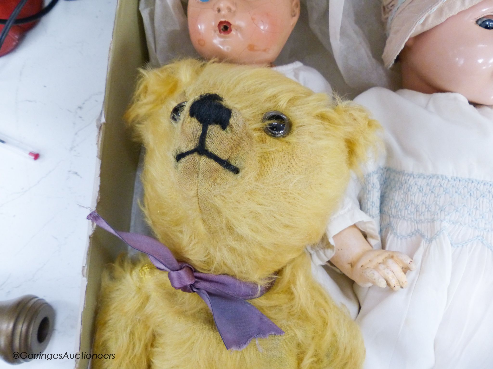 A 1939 Canadian reliable 'Netums' composition doll and a similar 'drunk-wet'doll, a gold mohair unjointed teddy bear and brown terrier